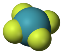 Un modèle de molécule chimique plane avec un atome central bleu (Xe) symétriquement lié à quatre atomes de fluor (périphériques).