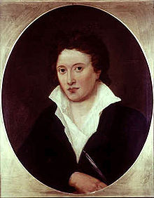 Demi-longueur portrait ovale d'un homme vêtu d'une veste noire et une chemise blanche, qui est de travers et ouvert sur sa poitrine.